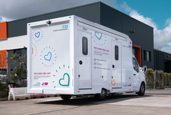 The Living Well Bus, large white van